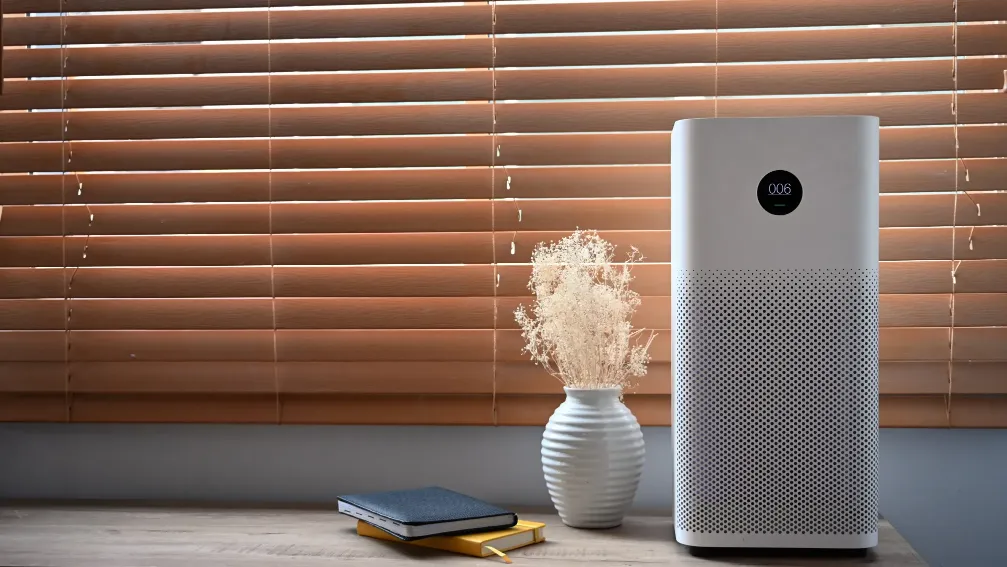 Air purifier in front of windows in living room