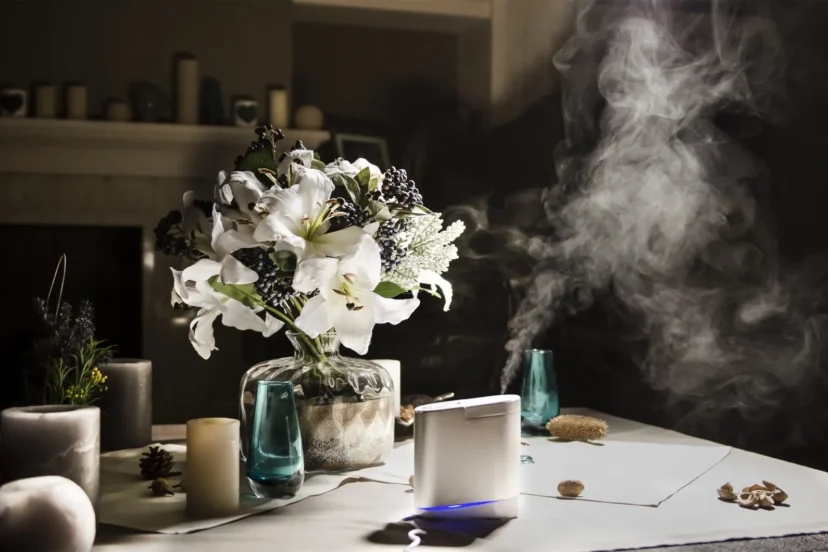 Humidifier on table with bouquet of flowers: A humidifier placed on a table alongside a beautiful bouquet of flowers, enhancing the home interior atmosphere