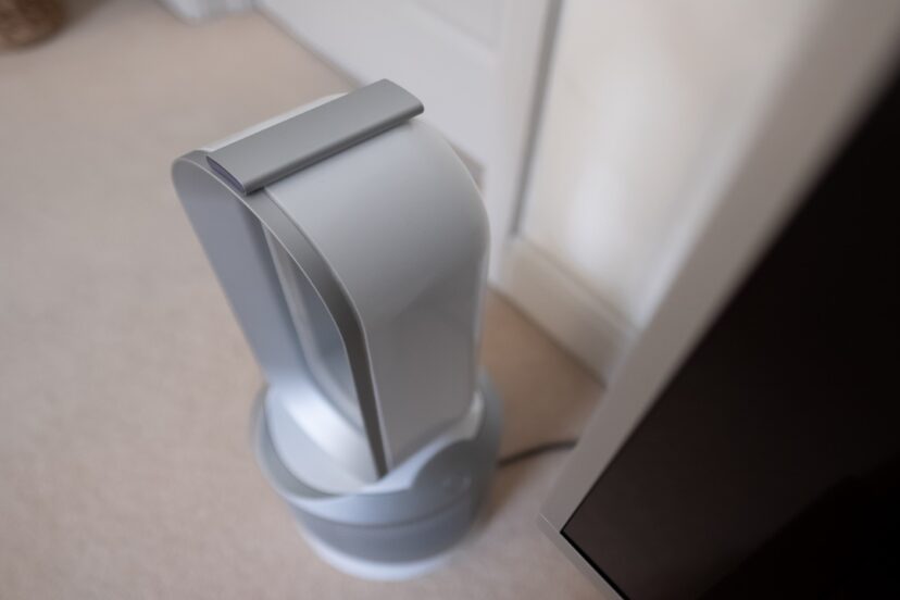 Dyson air purifier in a living room, half pristine and half with mold spores visual